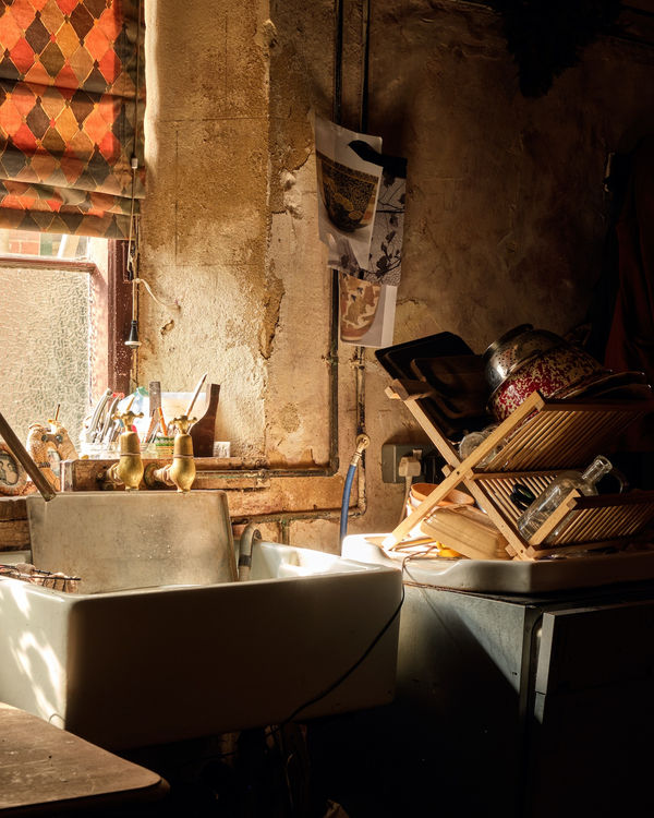 Light streams in through the windows of the old manor house kitchen