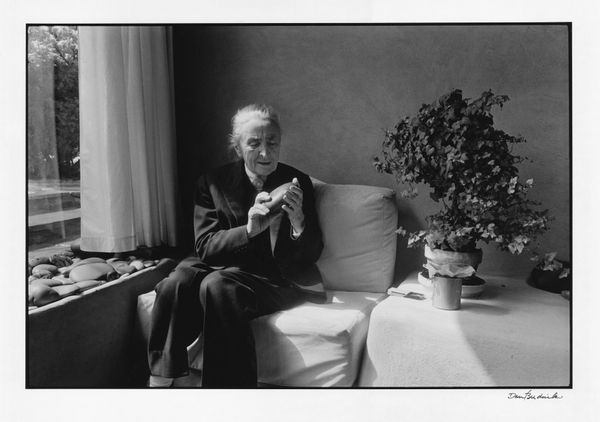 Dan Budnik (1933-2020) "Georgia O’Keeffe inspecting Chama River stone, Abiquiu, New Mexico," 1975 gelatin silver print