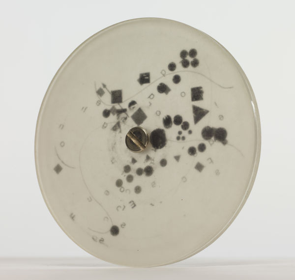 Mira Schendel Sem título [Untitled], da série [from the series] Discos [Discs], 1971 - 1973 acrílico opaco, letraset e parafusos [acrylic glass (opaque), transfer lettering (letraset), sccrew] ø 9 x 0.6 cm [ø 3 1/2 x 1/4 in]