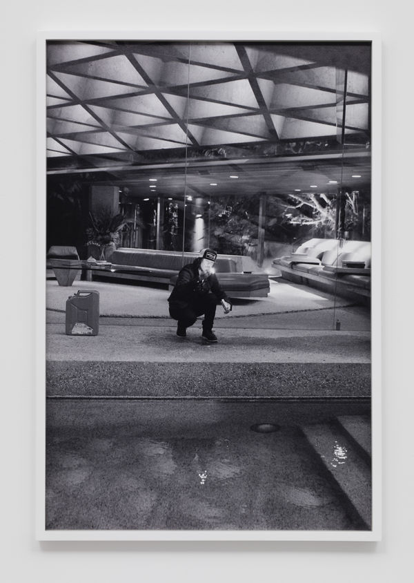 The artist Pig Pen stooped by an outdoor pool with a lit match in their hand.