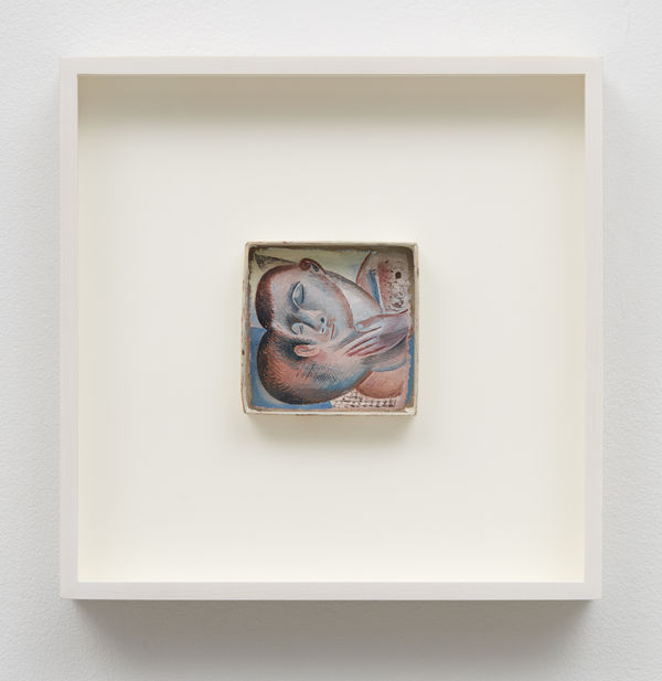 Framed painting showing two heads on their sides in a hugging position, one facing us and the other away from us.