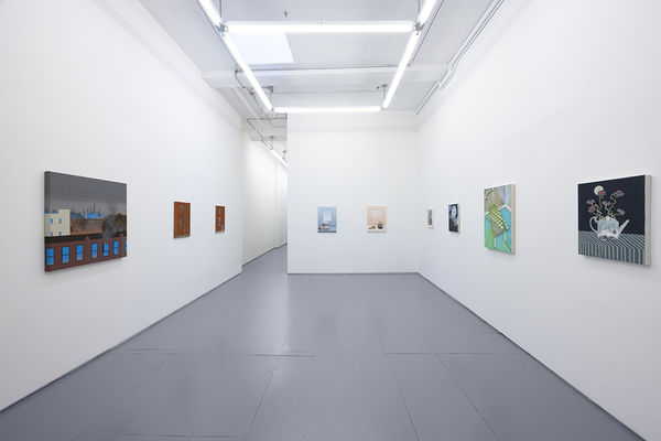 installation photo of "room with a view" exhibition featuring paintings by various artists in white walls