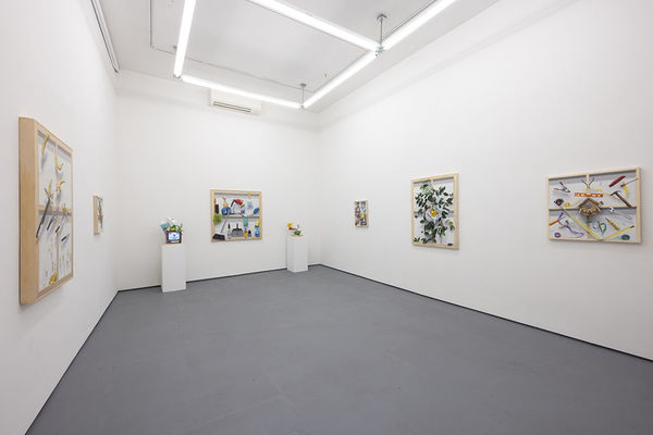 Paintings on wall with sculptures next to them at Stephen Morrison Dog show #4: House Broken exhibit