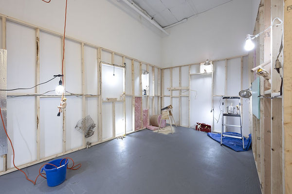 wooden scaffolding with assorted small statues of dog people scattered round at the Stephen Morrison Dog Show #4: House Broken exhibit