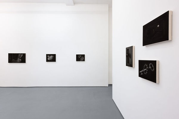 Installation view of Angela Fang Zirbes exhibition "House & Ghosts" featuring greyscale paintings on white walls