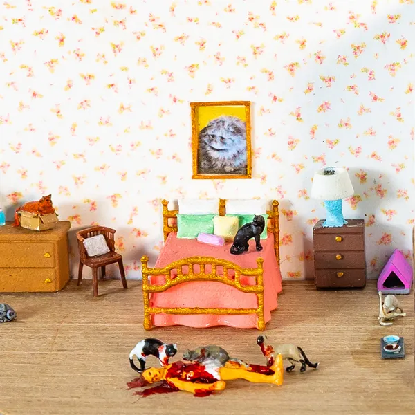 Abigail Goldman diorama of bedroom, cats eating dead figure on ground