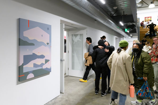 Photo of people in a gallery during an opening reception