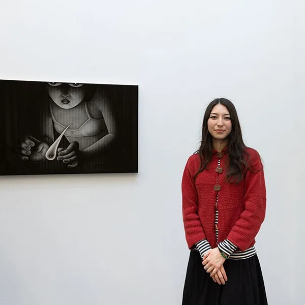 Angela Fang Zirbes standing next to one of her paintings