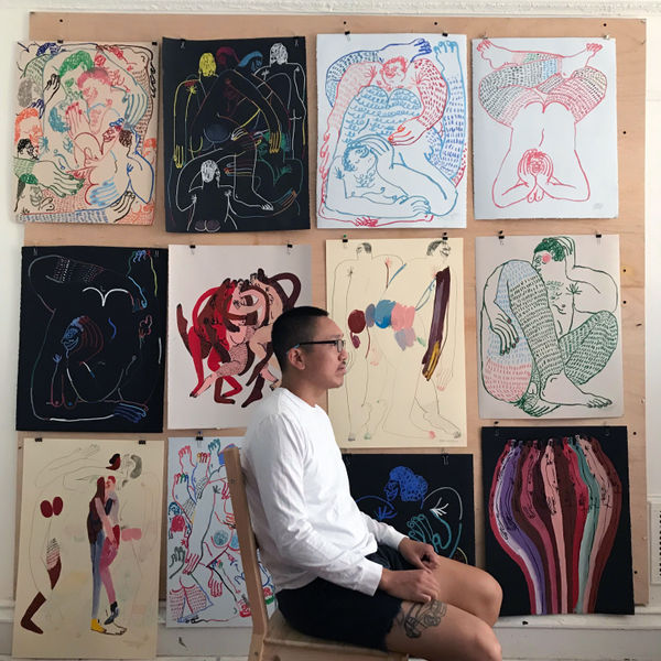 Portrait of artist Jeffrey Cheung in front of his new drawings