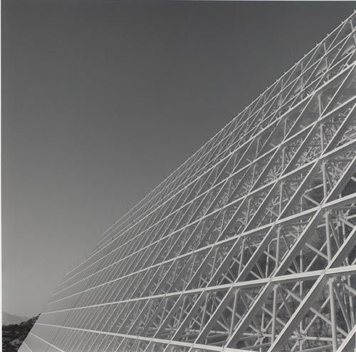 scaffolding of unique large-scale experimental apparatus angling toward right hand side of photograph, sky as negative space on left hand side