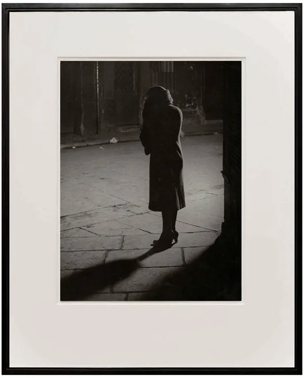 Woman on street at night by Brassai