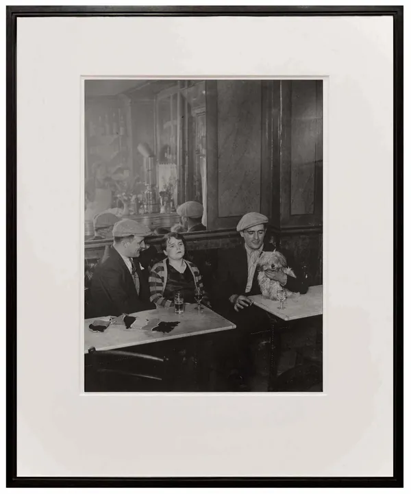 woman and two men at cafe from Paris de Nuit by Brassai