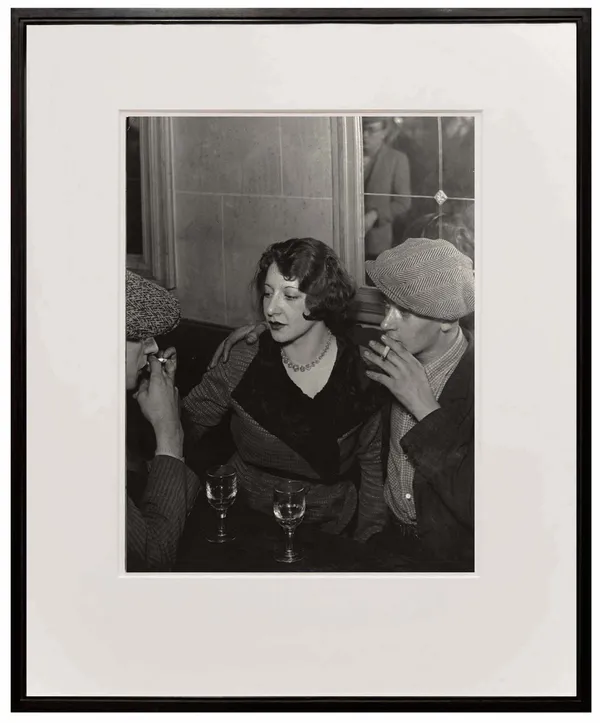 framed photograph of couple at the table smoking cigarette from Paris de Nuit by Brassai