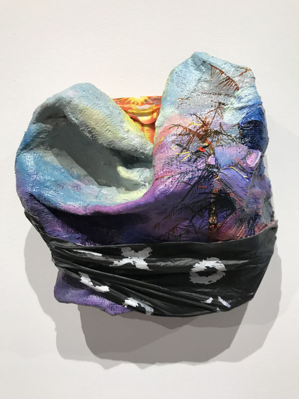 Camille Hoffman XO, 2019 oil, acrylic, Dole banana bag, play-by-play plastic tablecloth, nature calendar, plaster on wood 8 x 8 x 3 in.