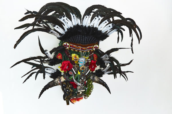 Mark Anthony Wilson Jr., Black Seminole Johanna July, 2022, cardboard, plaster wrap, acrylic paint, leather belt, faux flowers, bolts, shells, beads, nails, crosses, feathers, lighters, spoons, found objects, butterfly, mothers jewelry, camera, horse shoe