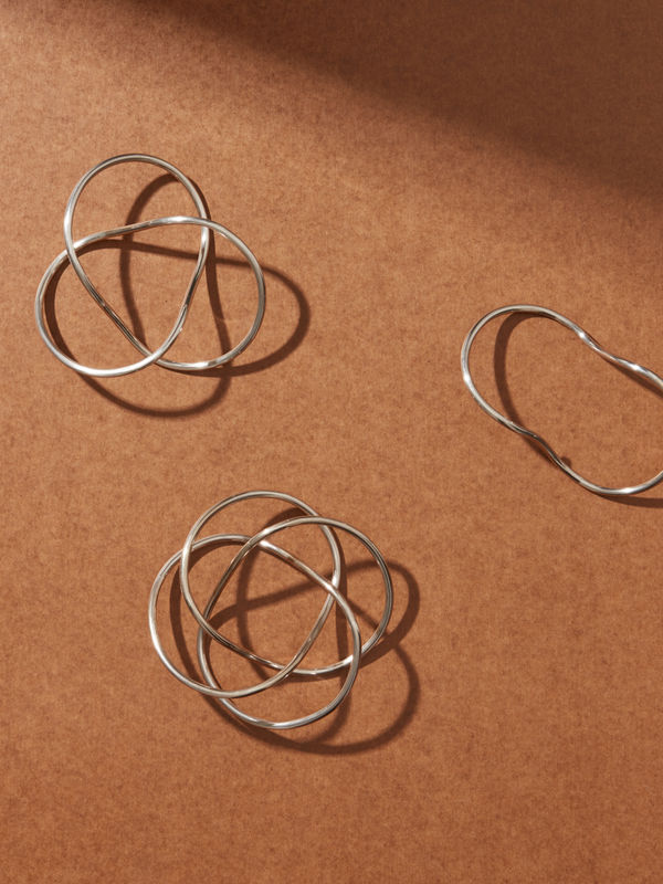 Conrad Shawcross, A Set of Seven Days Bracelet & Drawings, 2013, seven silver bracelets in a dedicated oak case, lined with a series of seven pendulum driven drawings by the artist, incised with artist’s signature, numbered & hallmarked and pendulum drawings are signed and inscribed; Bracelets: 14 cm (approximately), 2.5 kg per set; Drawings: 14.0 x 14.0 cm; Case: 21.1 x 131.5 x 7.5 cm, edition of 10 in collaboration with Louisa Guinness.