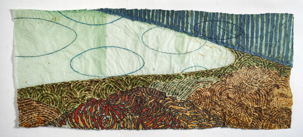 Nancy Cohen's "Underside" created using paper pulp, ink and handmade paper in shades of green, blue, brown and red. The work consists of four separate layers overlapping each other creating an illusion of depth. Each layer has a separate design pattern. 