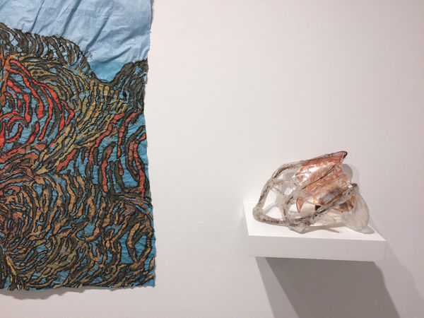 Installation shot of two different art pieces by Nancy Cohen. The pieces are "Low Tide" (left) and "Intercoastal" (right). Only the bottom right corner of "Low Tide" was shot.