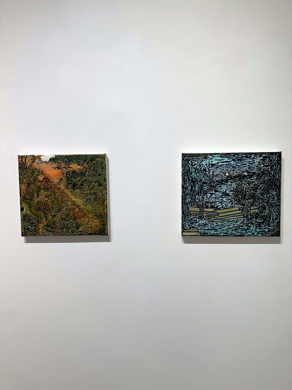two abstract paintings on a wall
