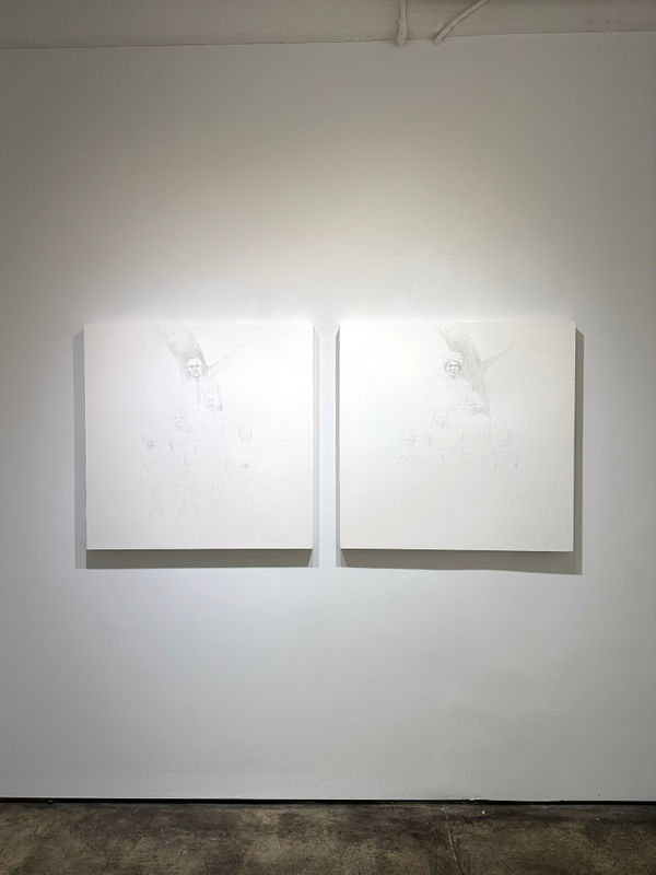 photo of an installation, with two primarily white paintings next to each other on the wall.
