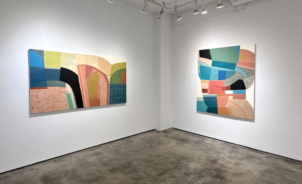 exhibition with two large geometric abstract paintings, cool in tone, on the walls