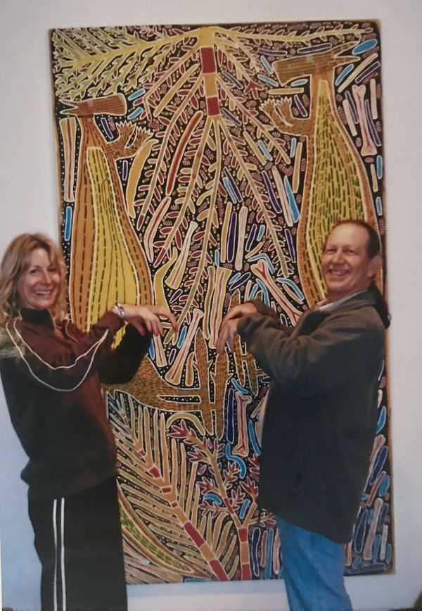 Rebecca Hossack and Steve Morgan in front of Two Yellow Kangaroos painted by Sambo Barra Barra