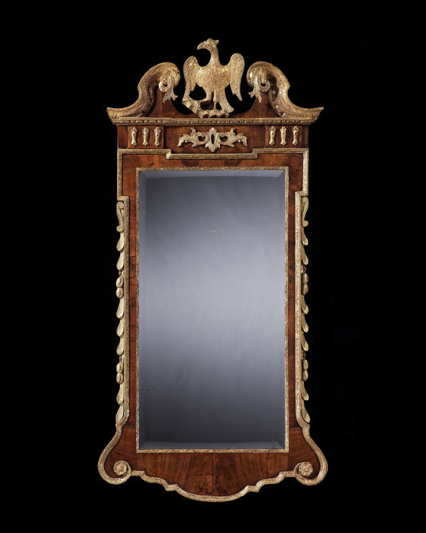 A GEORGE II PARCEL GILT WALNUT MIRROR