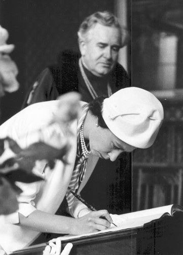 The Queen signs the visitor book at the 1961 Annual Exhibition.