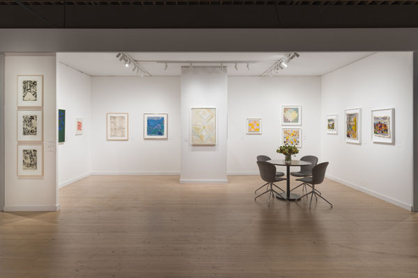 installation view of an art fair booth with various artworks