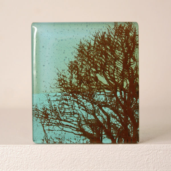 Helen Slater glass standalone sculpture with a sepia drawing of tree branches cast in light Teal glass