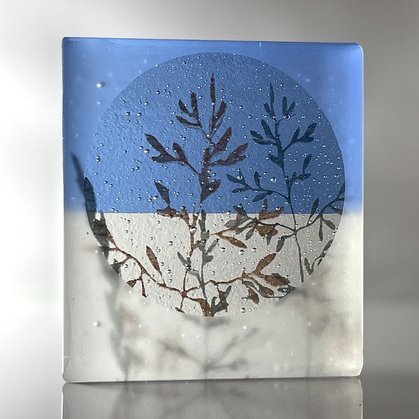 Helen Slater glass sculpture in sky blue and frosted glass with black and sepia drawings of grasses