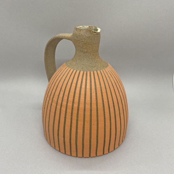 Kate Garwood brown jug with an orange body and tall neck.