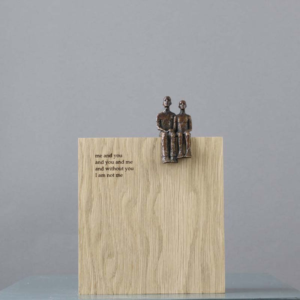 Carol Peace poetry block, a small sculpture in bronze of a couple seated on a wood block with text of a poem.