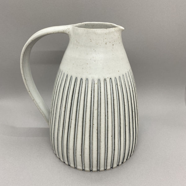 Kate Garwood white tall jug with slightly round shape, with thin blue stripes.