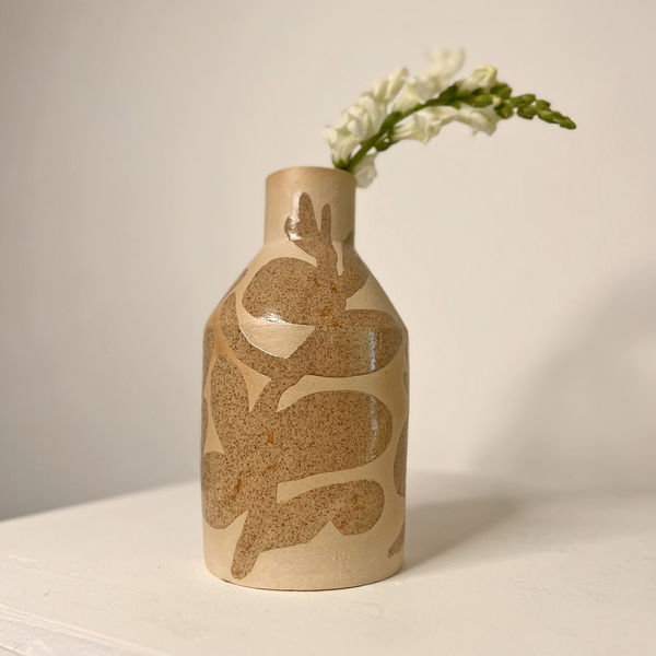 Sophie Alda diamond shaped ceramic vase with an oatmeal colour bisque fired base and hand painted shiny leaves