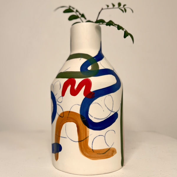 Sophie Alda diamond shaped ceramic vase glazed white biqsue fired base and hand painted rainbow patterns