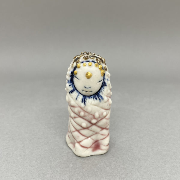 Marina Bauguil tiny sculpture of a plant spirit in the shape of a small pine cone in pink., gold detail on its head.