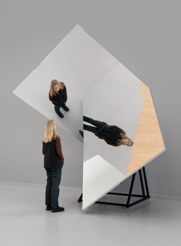 Two rectangular mirrors intersect at a right angle, reflecting a viewer.