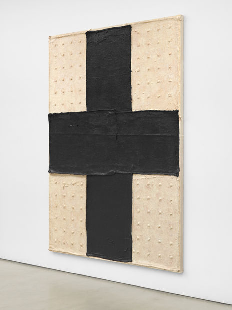Among the most recent paintings is Black Cross (2020) which incorporates found burlap and grommets inserted in an irregular grid...