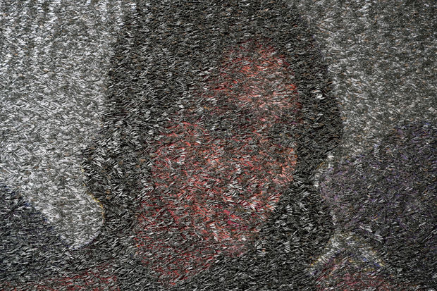 Photograph of a woman's face covered by staples