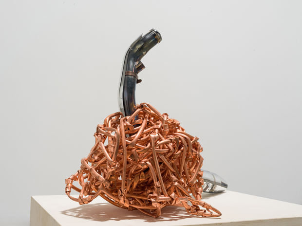 In Weaving (2016), an exhaust pipe intended use is trapped into a ball of copper tubes weaved ad knotted together....
