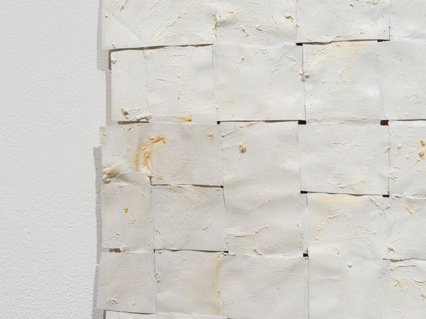 Titanium White No. 2 (2014) is composed of woven canvas strips that Sharif paints over, suspends, and binds using a...