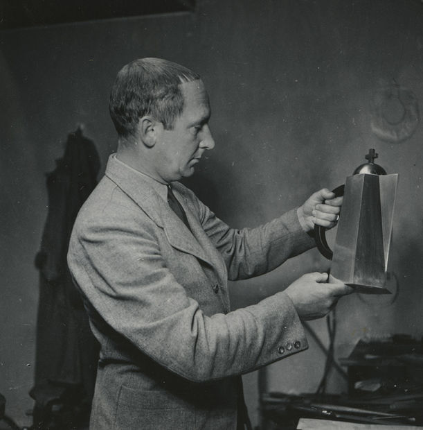 Wiwen Nilsson holding a communion wine jug.