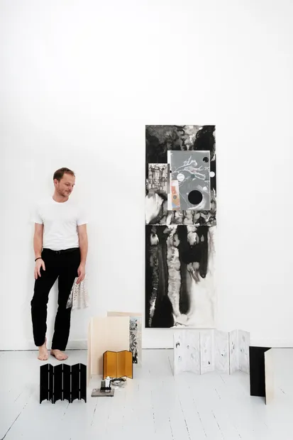dirk standing with artworks