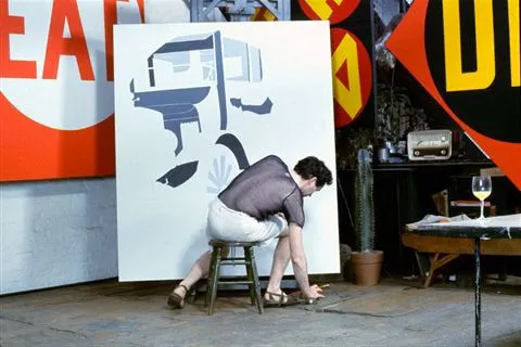 Robert Indiana starts "A Father is a Father" panel from "Mother and Father" diptych (1963-67) with "EAT/DIE" diptych on wall, Coenties Slip studio, Lower Manhattan (Chromagenic print by William John Kennedy, executed 1963, printed 2008)