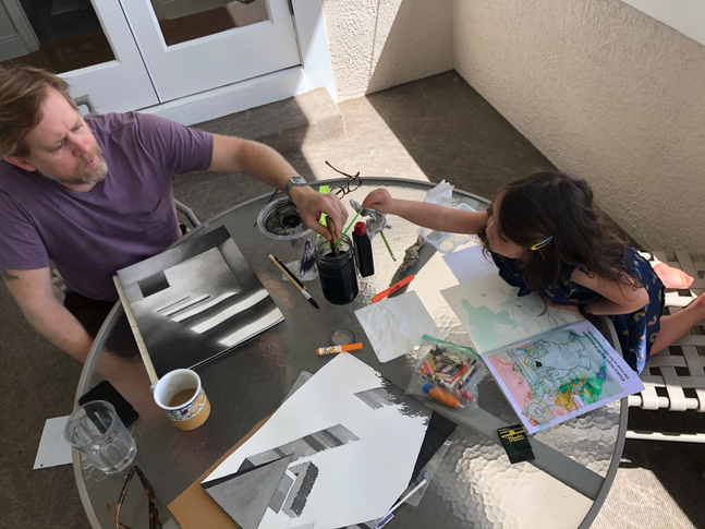 Ballantyne at work in his makeshift studio, with his assistant.