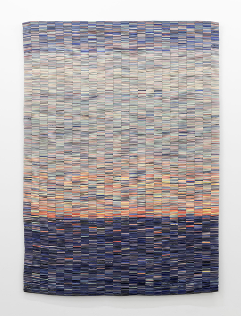 An artwork by Nadia Myre of ceramic tubular beads strung together into a cohesive rectangular with dark blue beads at the bottom and lighter orange, yellow and blue beads above.