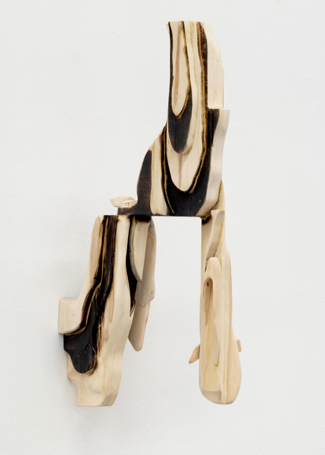 A wall mounted sculpture by David Armstrong Six of abstract geometric pieces of wood adhered together.