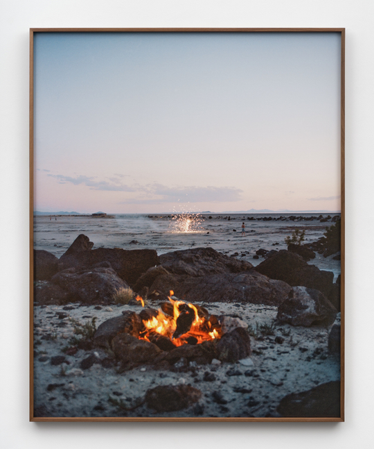 A photograph by Elise Rasmussen of a bonfire and fireworks at the Spiral Jetty.