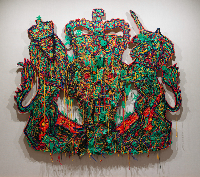 Hew Locke
Veni, Vidi, Vici (The Queen&amp;#39;s Coat of Arms), 2004
textile, plastic, oil stick, artificial hair, plywood
84 1/4 x 96 ins.
214 x 244 cm